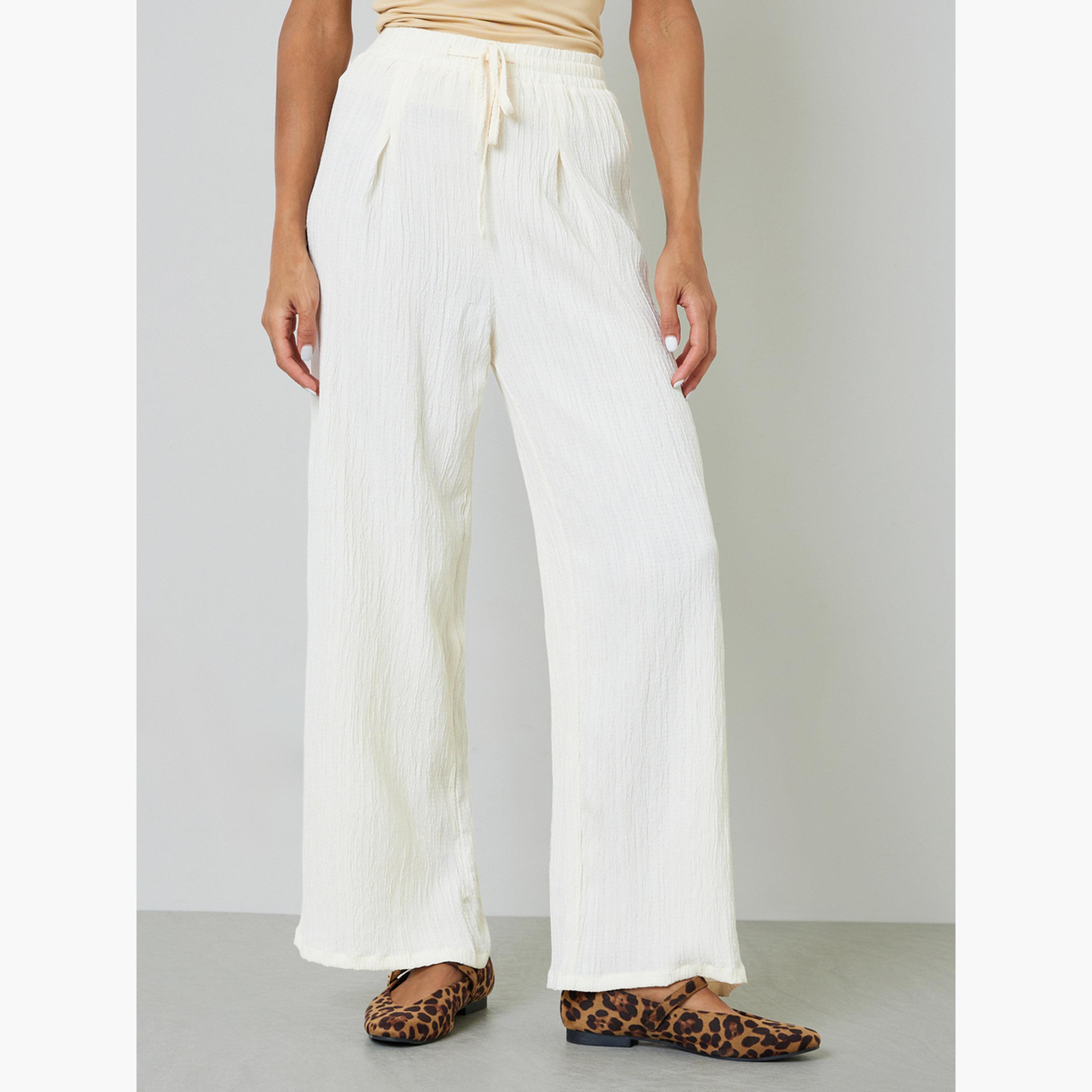 بنطال بمظهر مجعد وأرجل واسعة باللون الكريمي-women-clothing-joggers-image-1