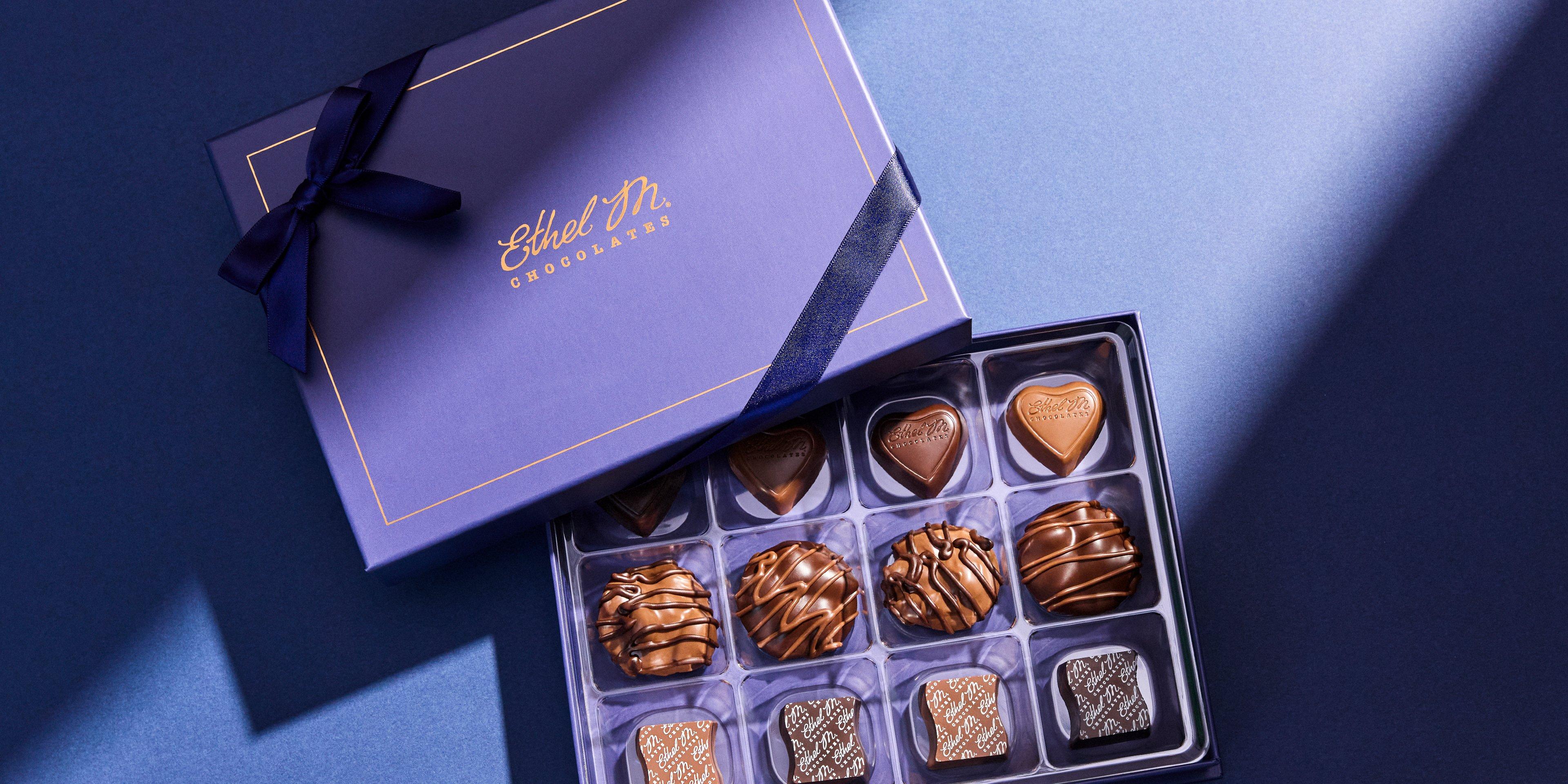 Milk and Dark Favorites Collection in a Sapphire Box and Sapphire ribbon opened with light shining