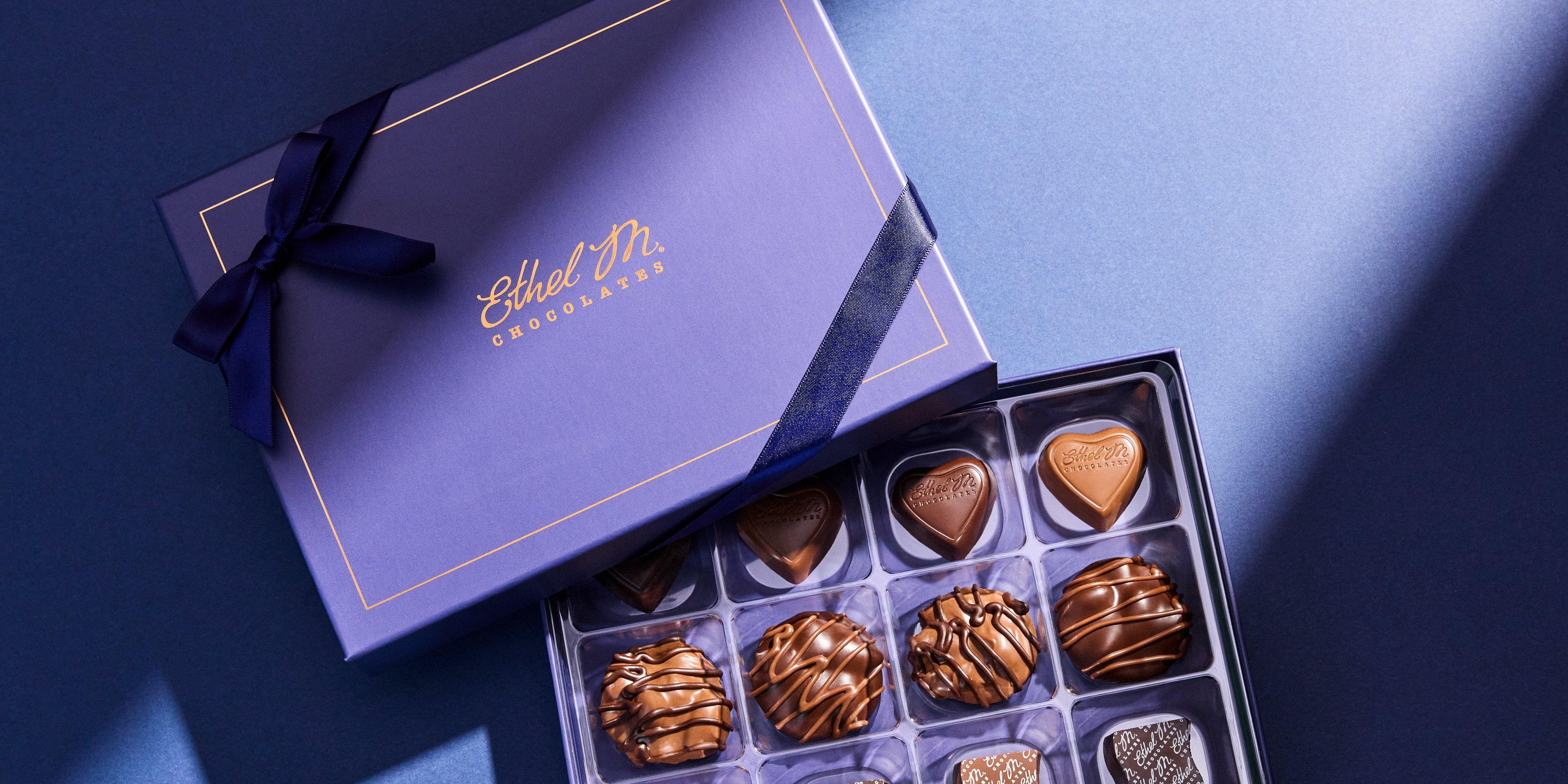 12 piece Sapphire Custom Chocolate Box with Sapphire Ribbon filled with dark chocolate and milk chocolate gems on sapphire background