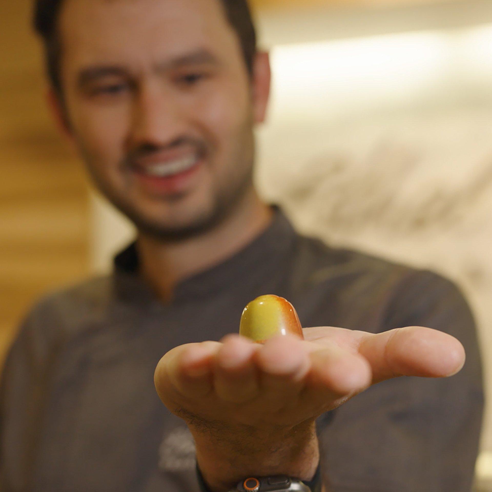 Chocolatier Mark Mackey holding chocolate truffle on hand
