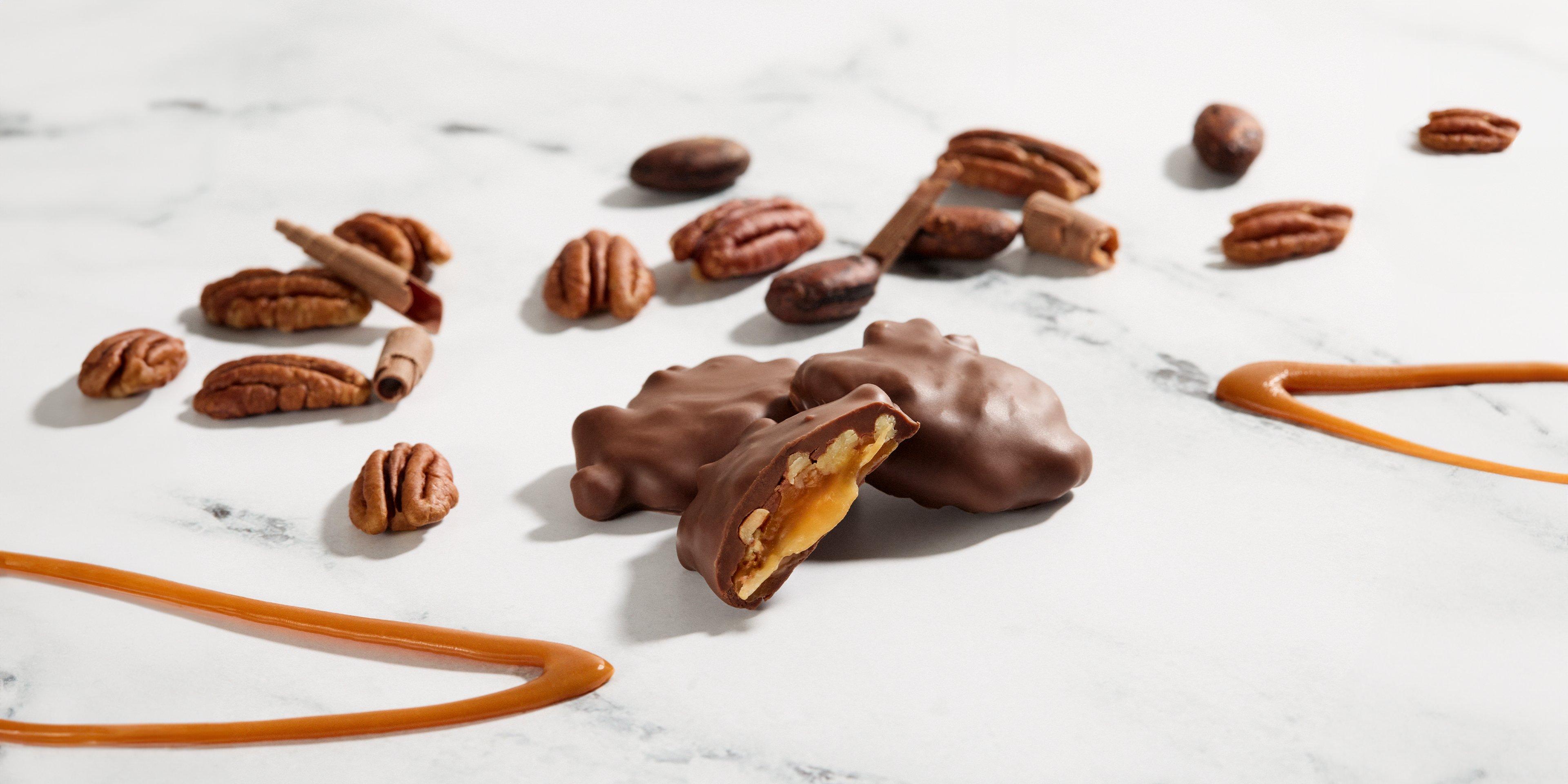 Pecan Caramel Rapture Milk Chocolate with pecans & caramel on a marble backdrop