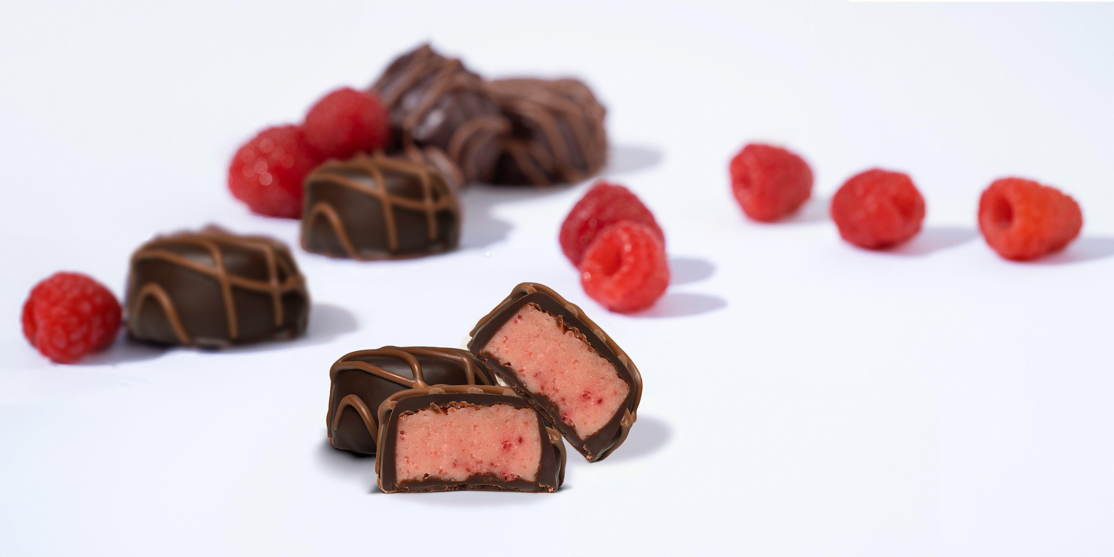 Raspberry Satin Creme Dark Chocolate with raspberries on white background