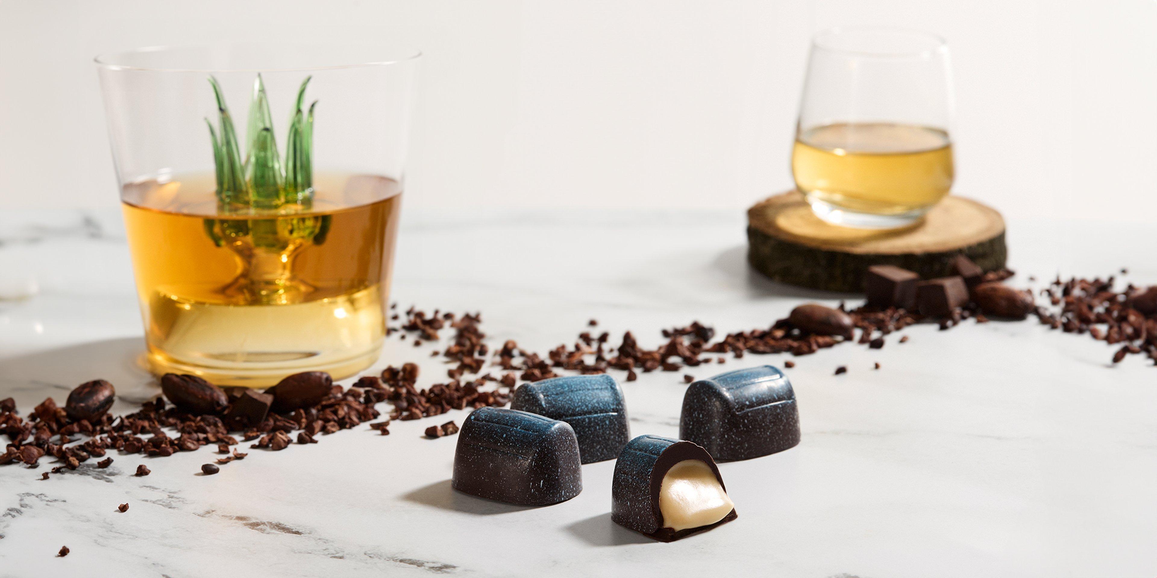 Herradura Anejo Tequila Crème Liqueur, Dark Chocolate with tequila glasses on marble background