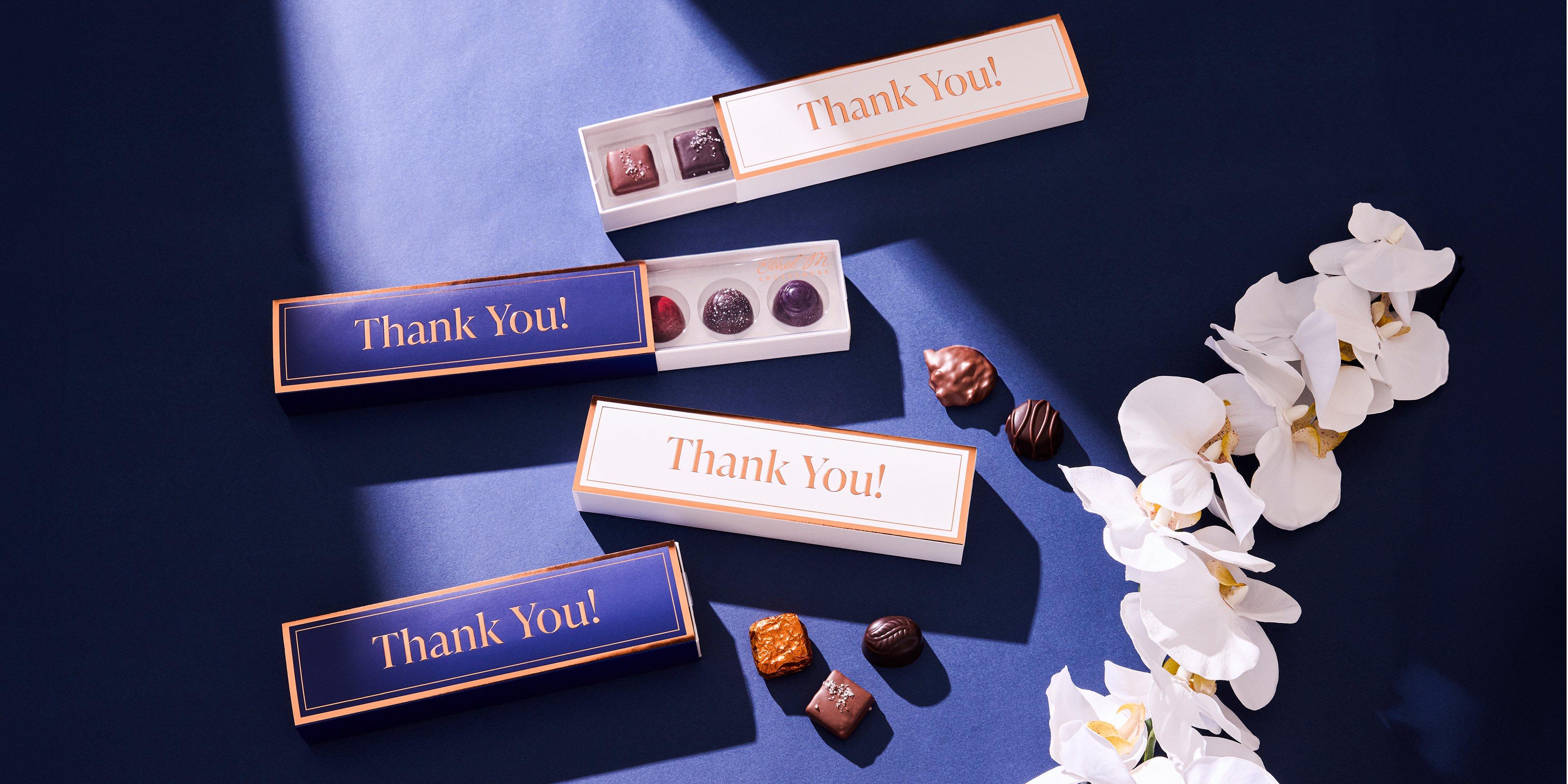 cream and sapphire Thank You Sleeves on 5 piece Samplers on sapphire background with white flowers