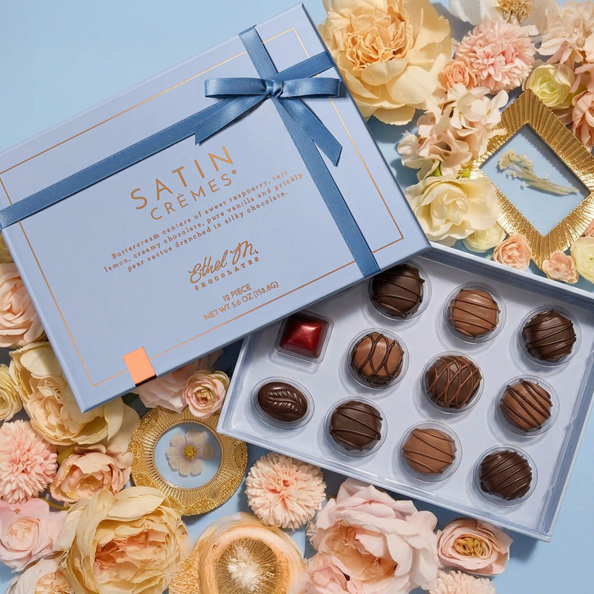 Satin Creme Collection on light blue background with flowers