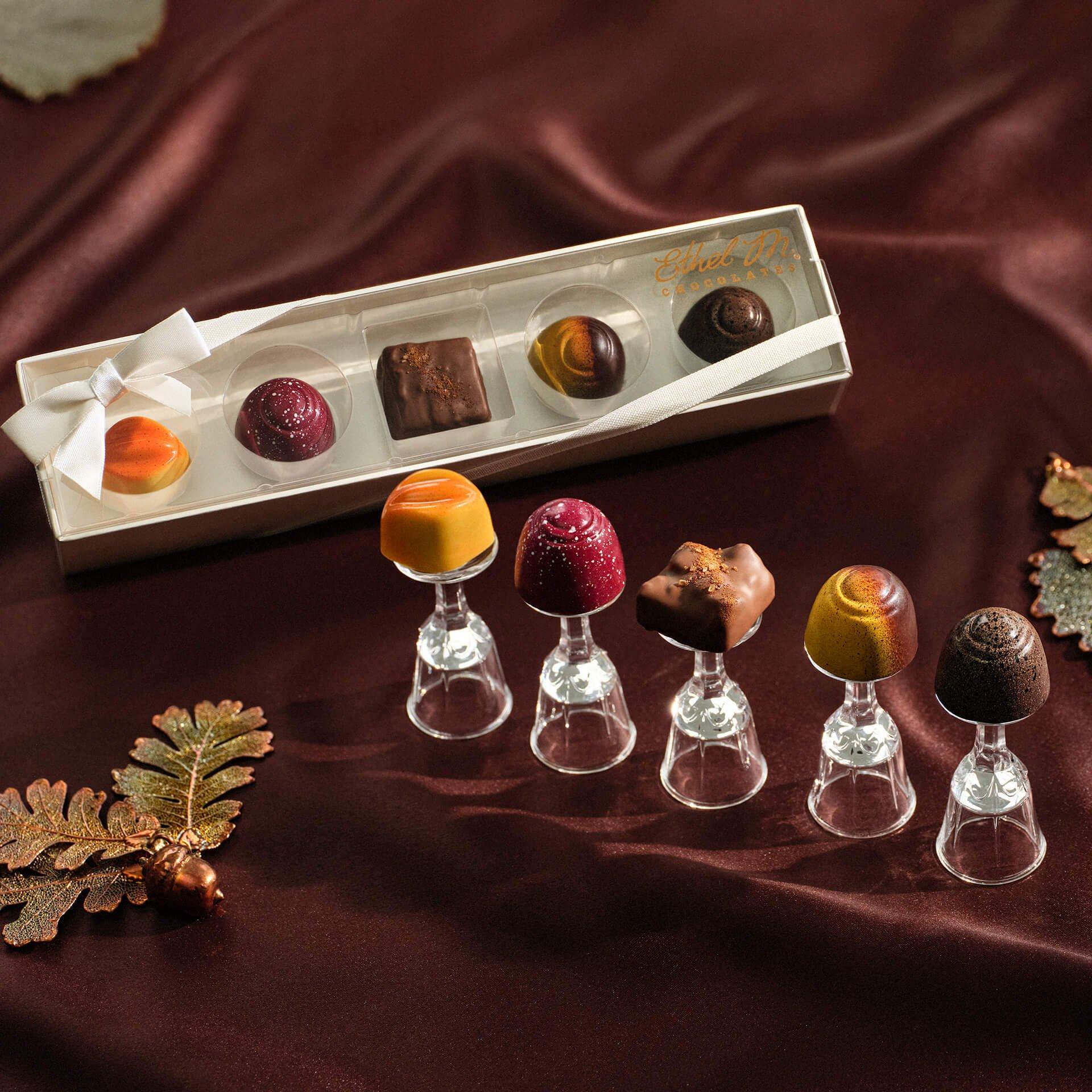 5 piece Fall Favorites Sampler with each piece on a glass tier on silky brown background with leaves