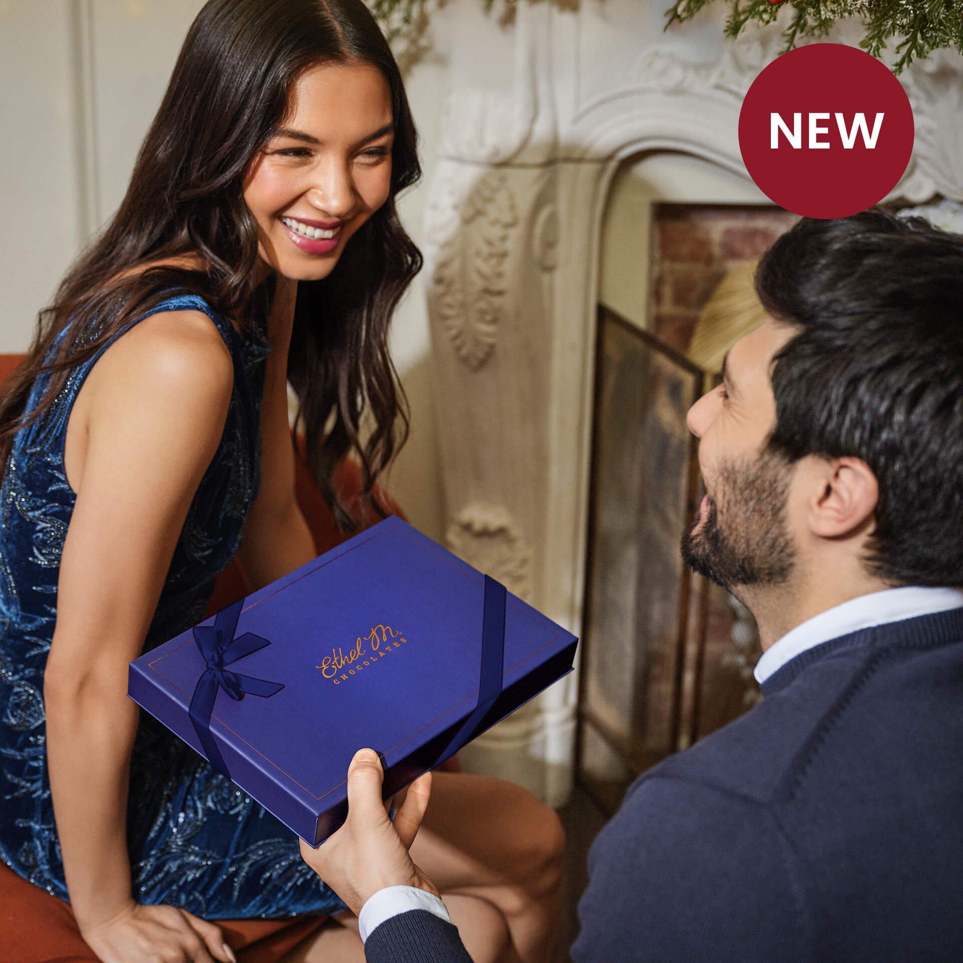 Man gifting a woman an Ethel M Chocolates Custom Chocolate Box