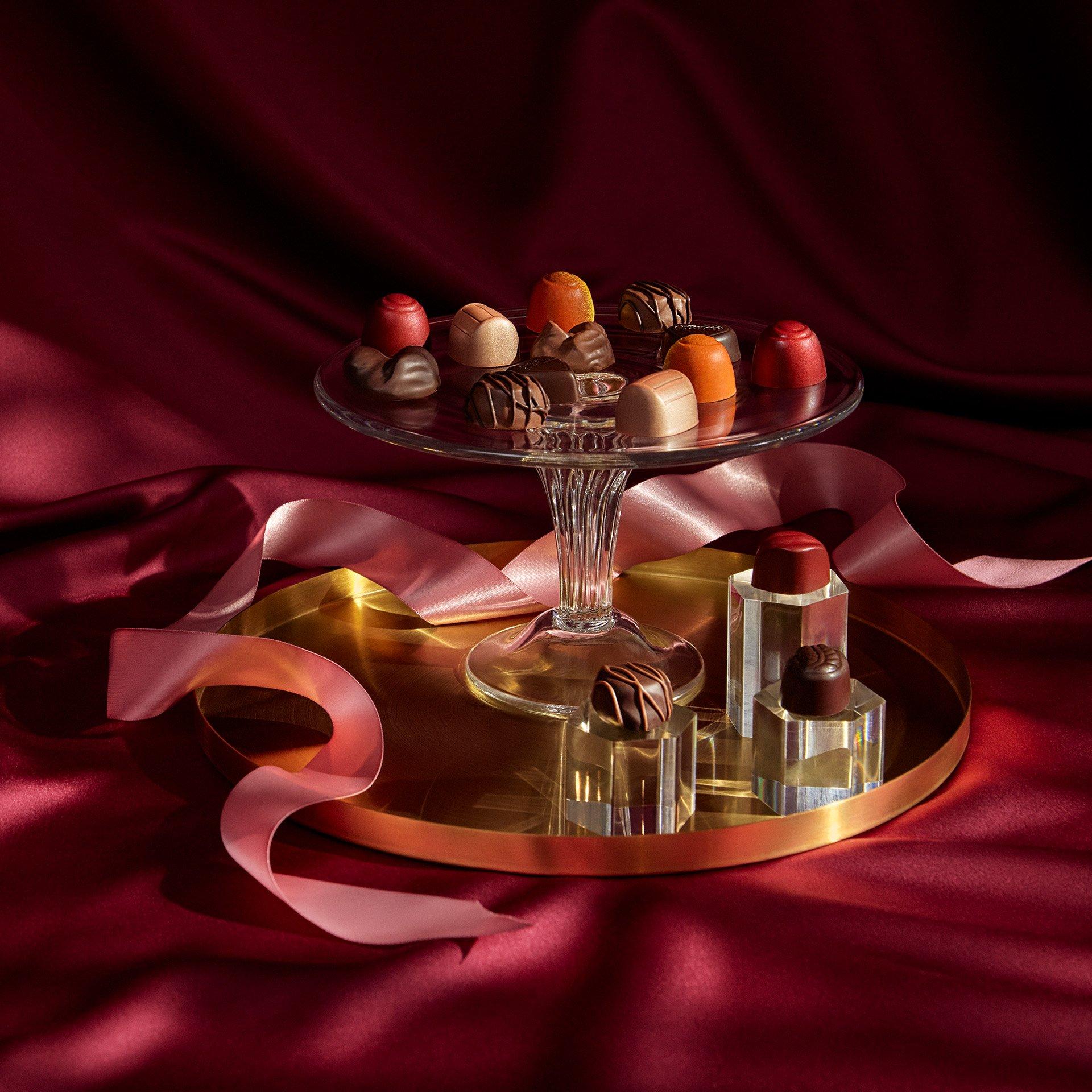 Chocolate pieces on a platter with a crimson background