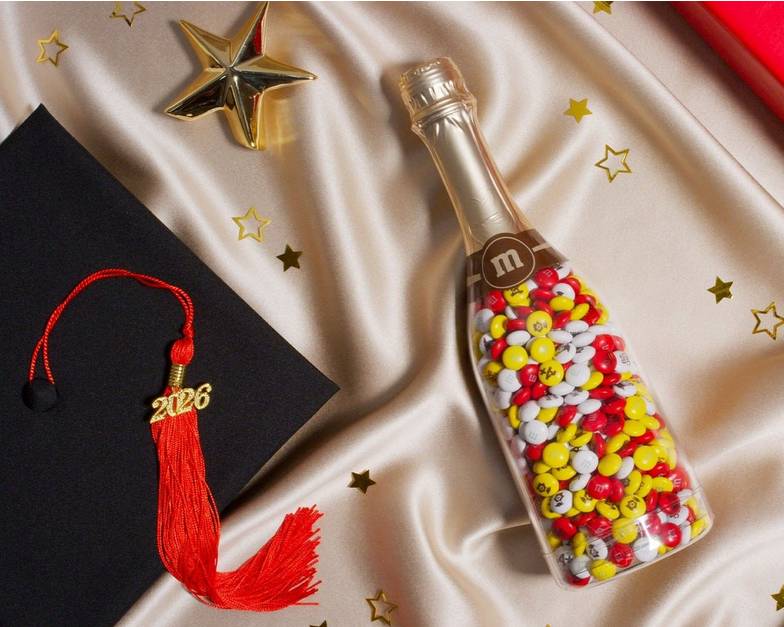 gift bottle on table with graduation props