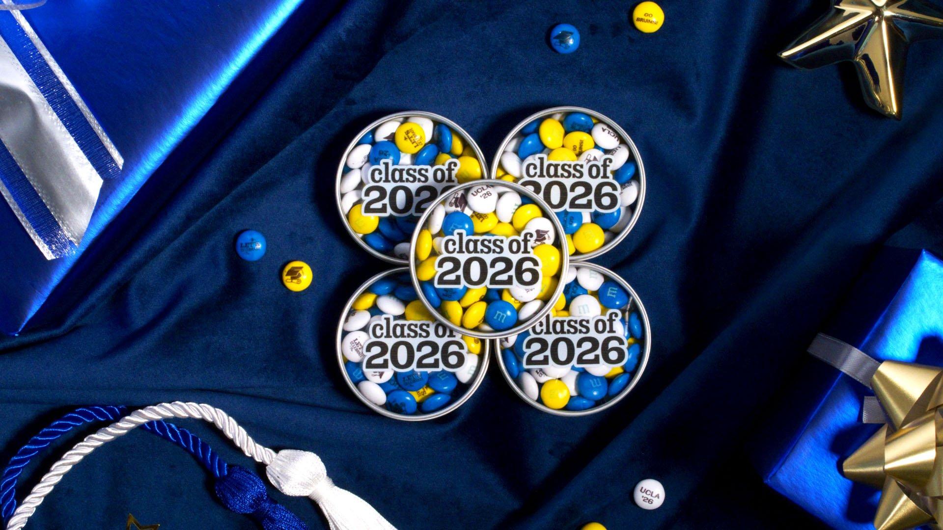 stack of class of 2026 favor tins on table