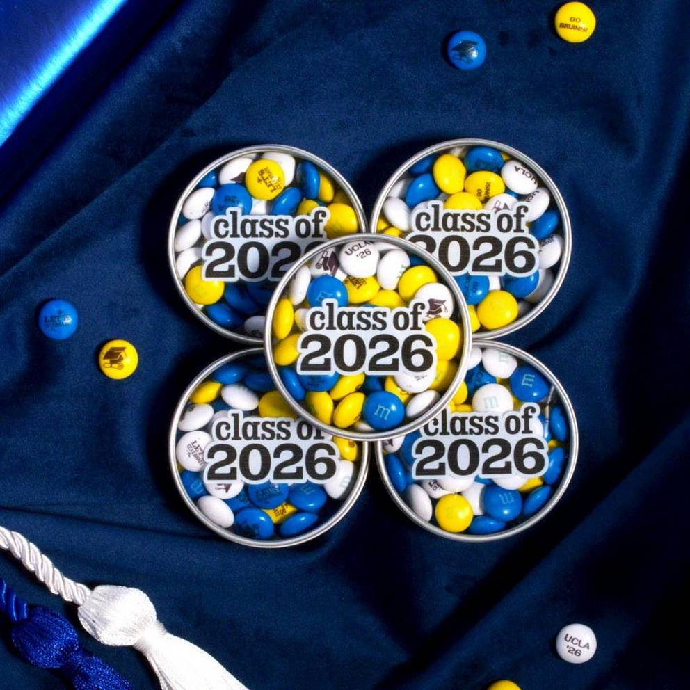 stack of class of 2026 favor tins on table