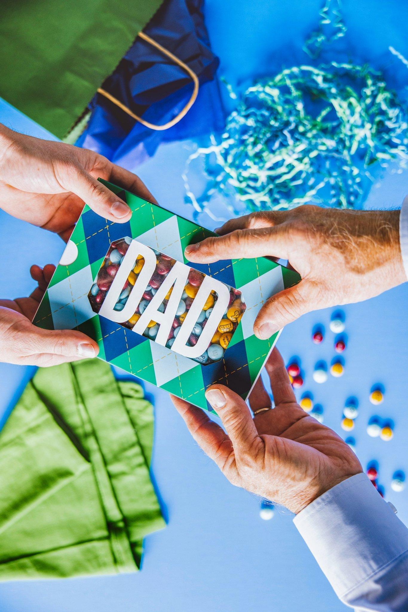 Dad gift box filled with personalized M&M'S being handed to recipient