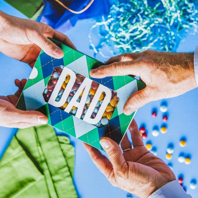 Dad gift box filled with personalized M&M'S being handed to recipient