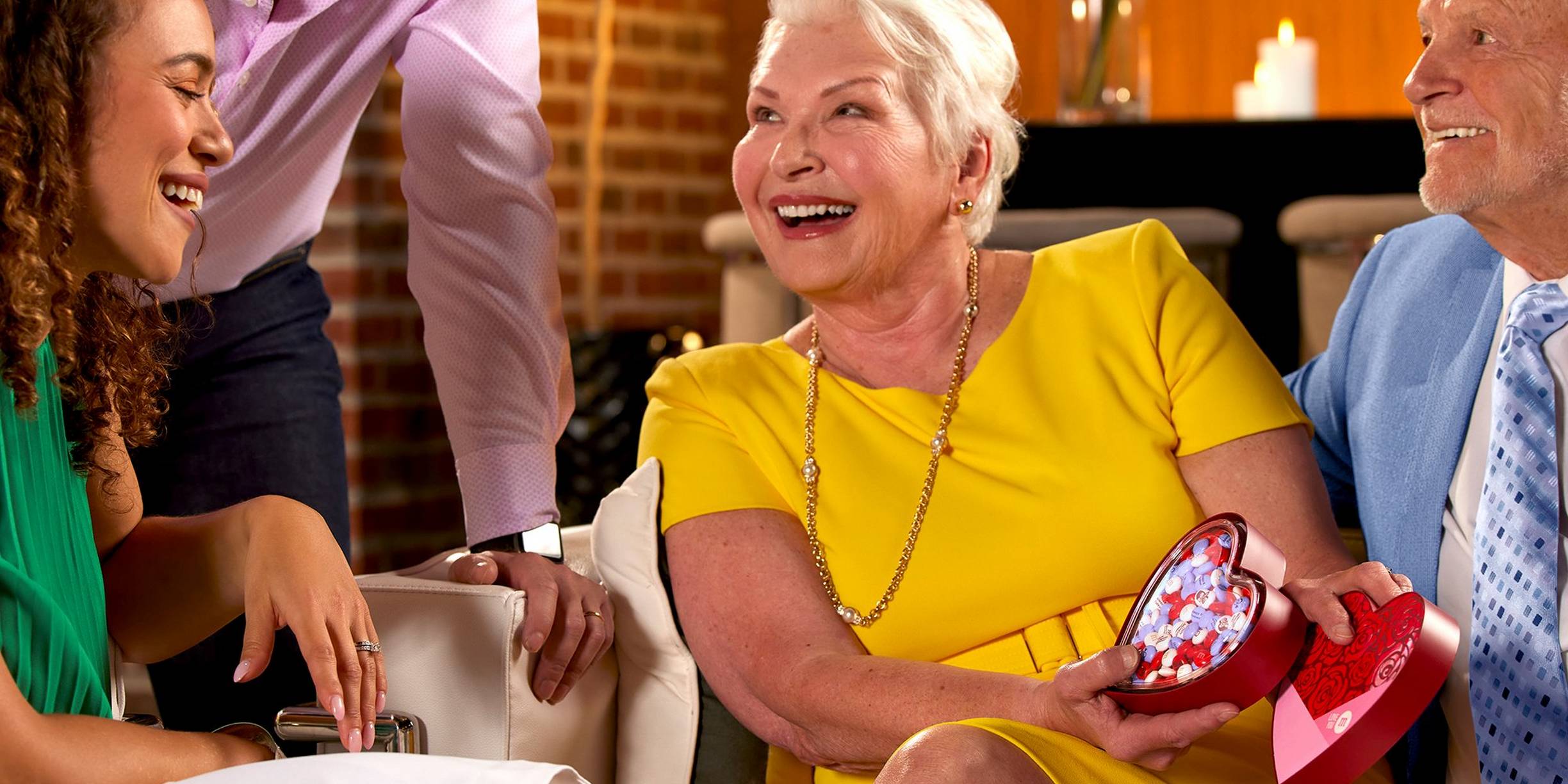 four people smiling and celebrating an anniversary