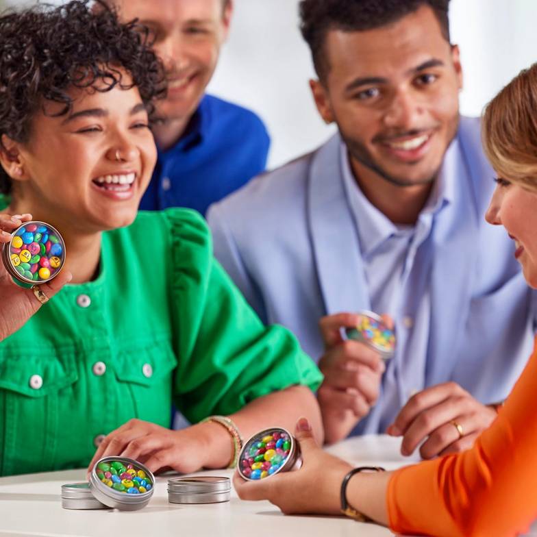 co-workers enjoying one another's company and collaborating with personalized m&m's packs