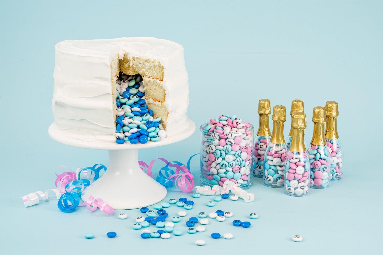 baby boy gender reveal cake with blue and white personalized M&M'S spilling out