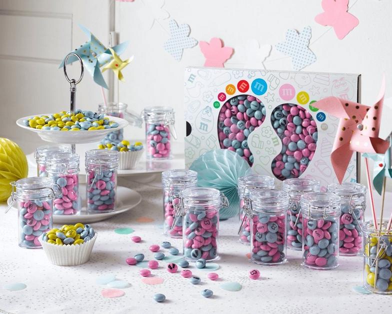 party favors with pink and blue M&M'S at a christening celebration