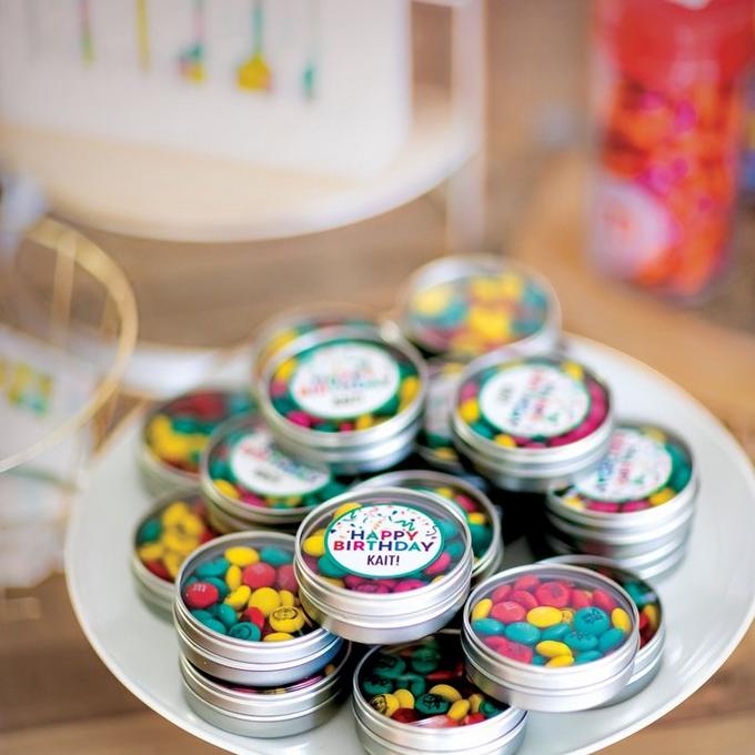 personalized M&M'S filled favor tins on display for birthday party