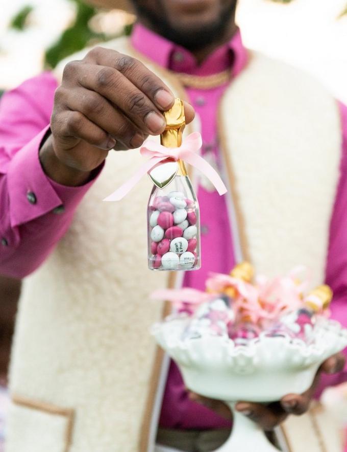 Man holding a mini M&M's bottle wedding decoration
