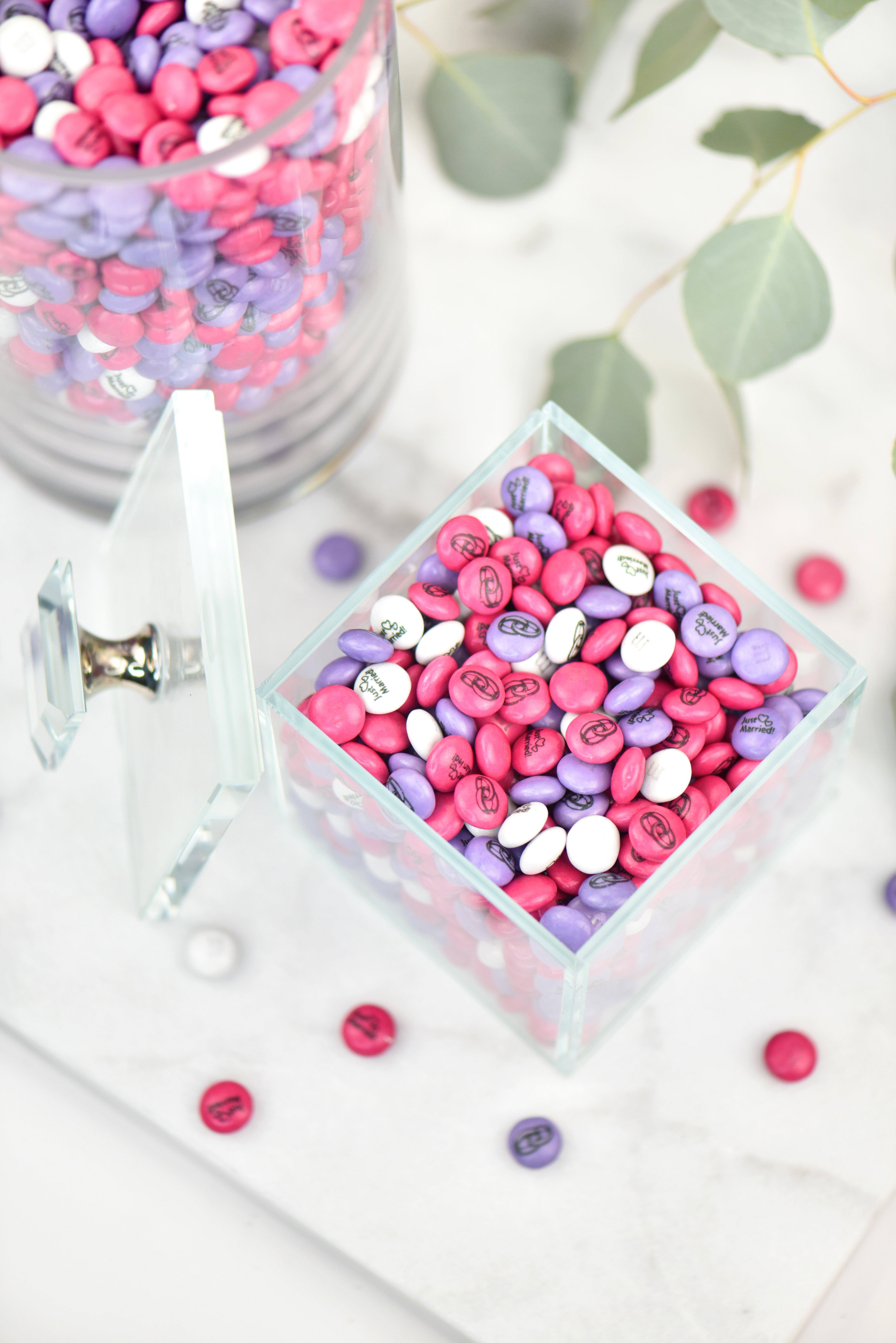 bulk canisters filled with personalised white, dark pink and light purple M&M'S