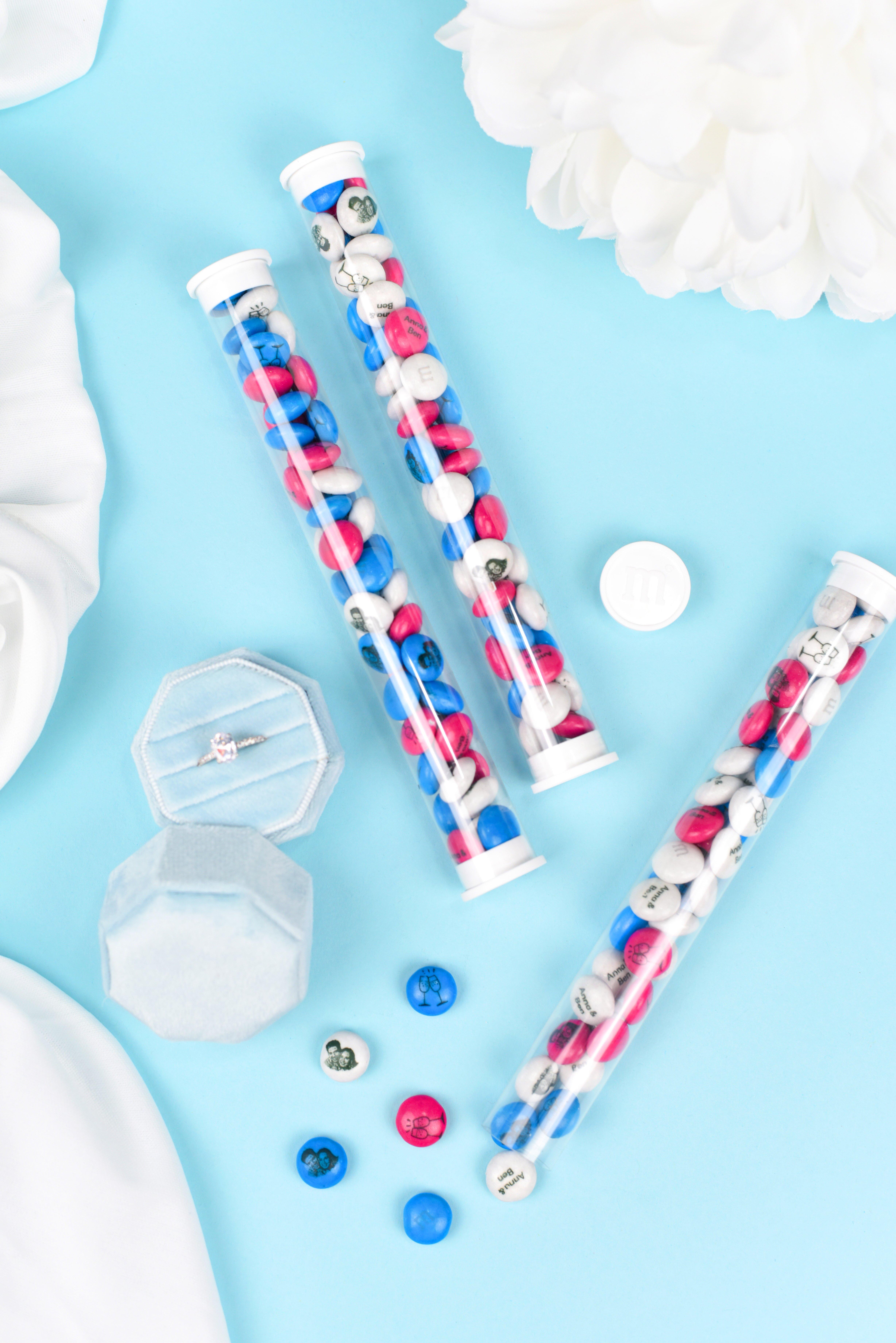 favor tubes filled with personalised M&M'S on table