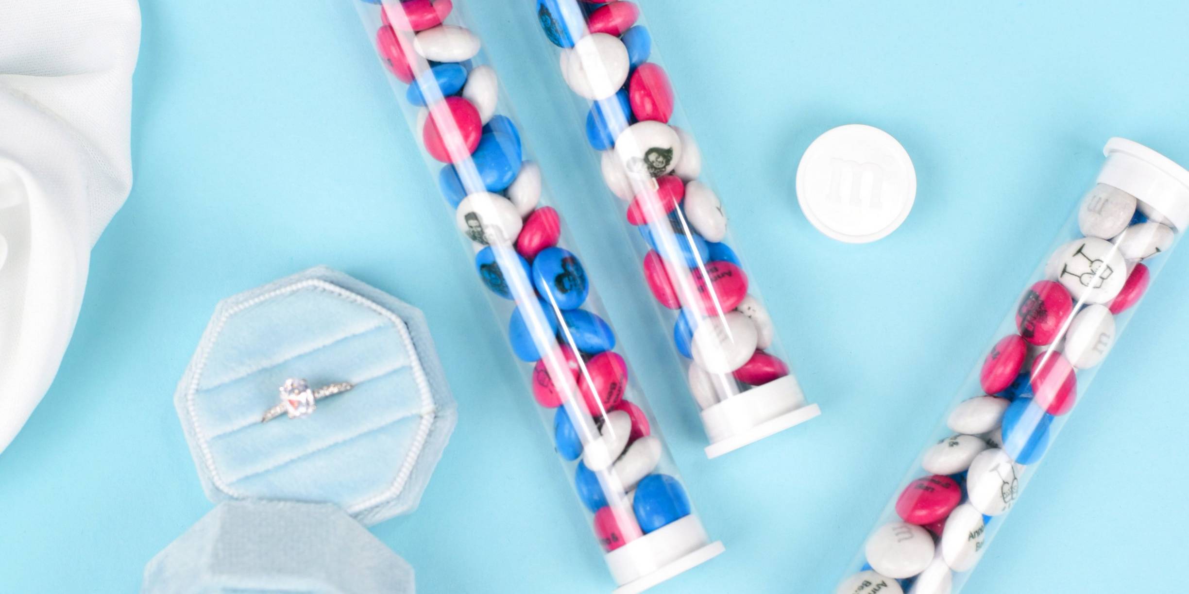 favor tubes filled with personalised M&M'S on table