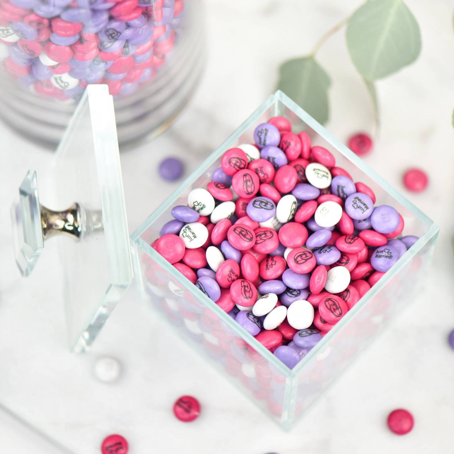 bulk canisters filled with personalised white, dark pink and light purple M&M'S