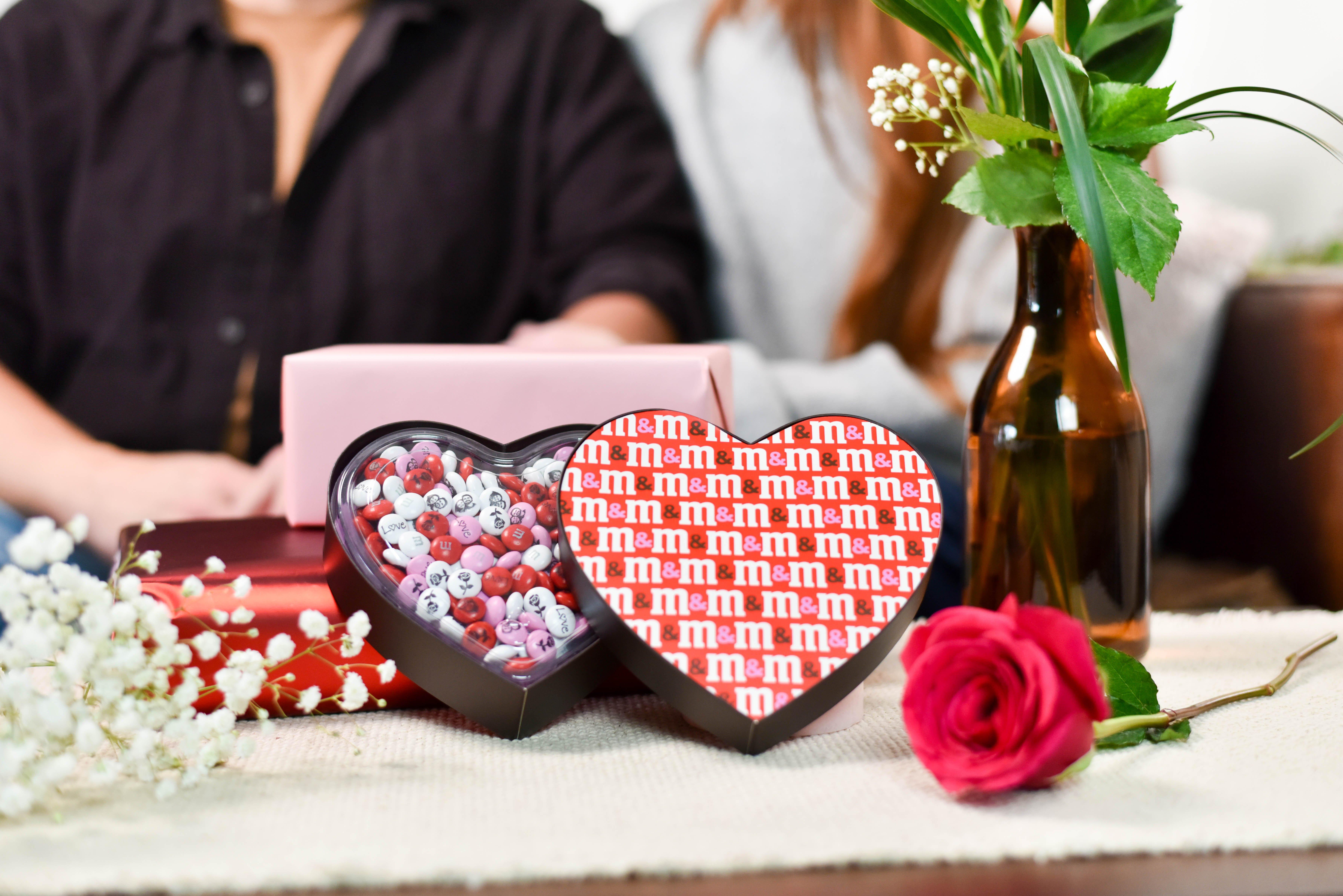heart m gift box on table with other valentine's day propping