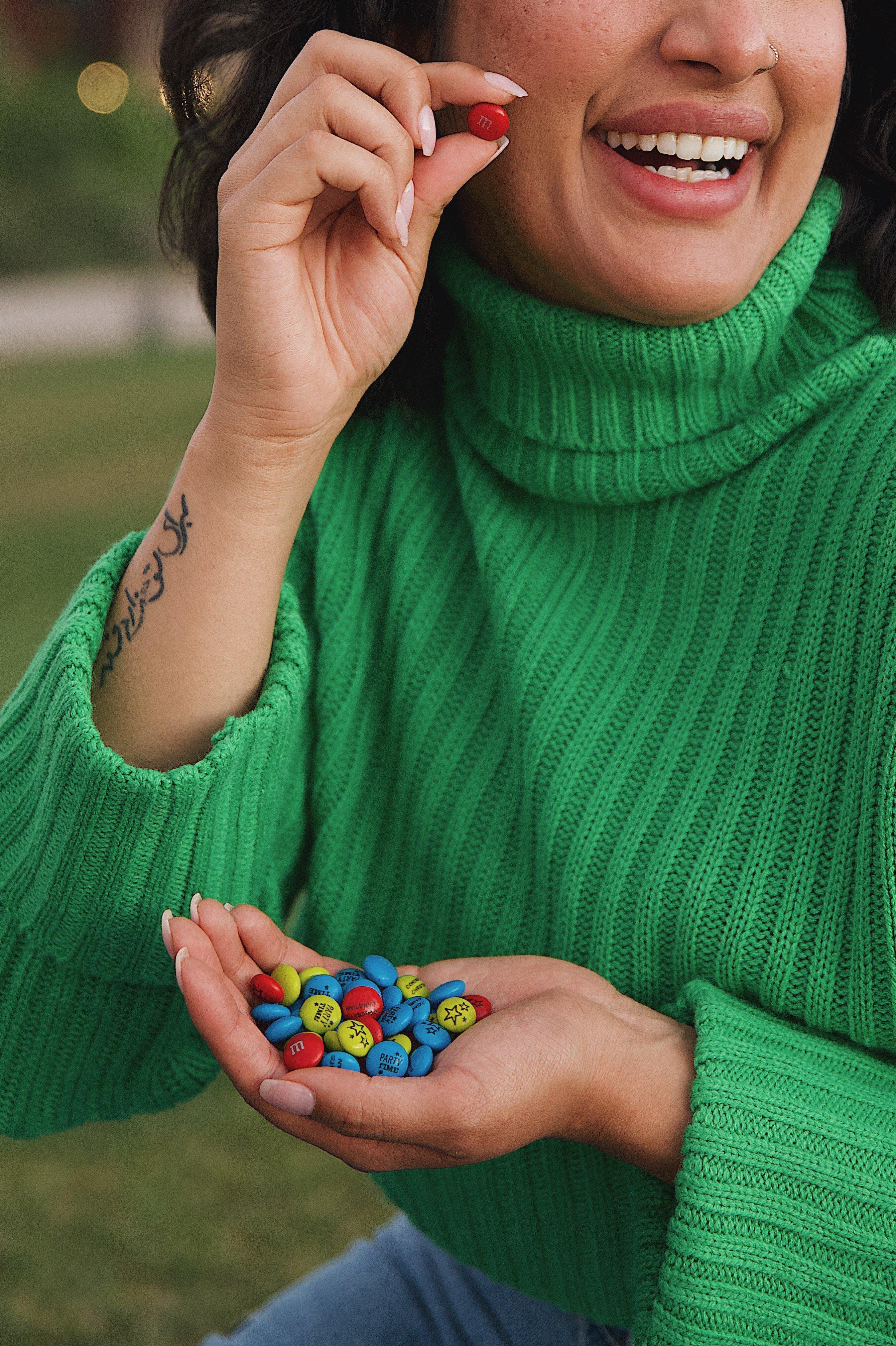 woman holding M&M'S in her hand