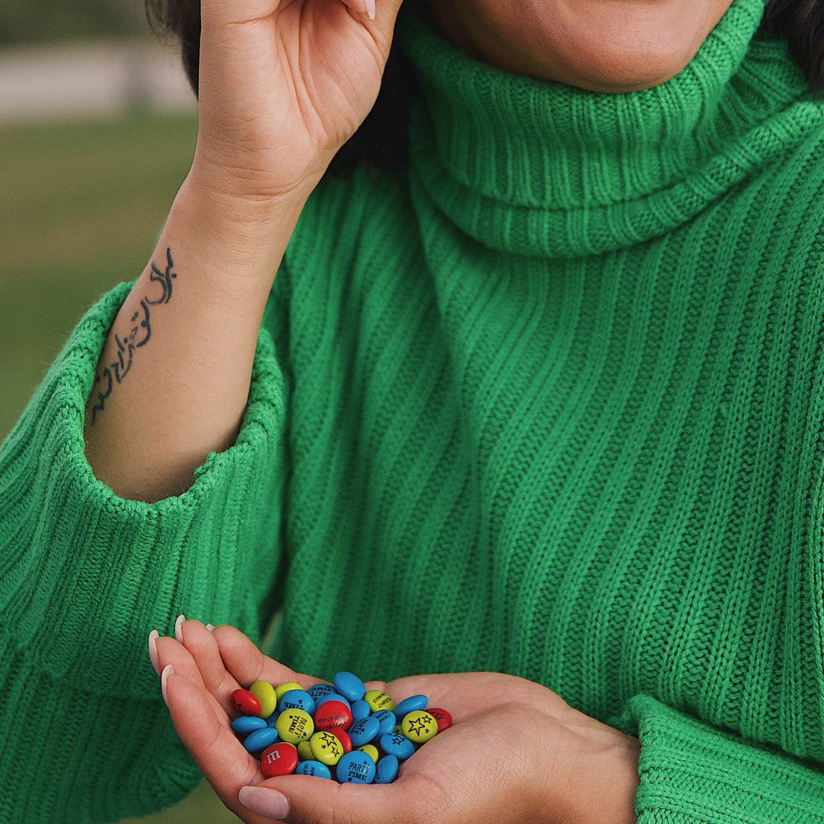 woman holding M&M'S in her hand