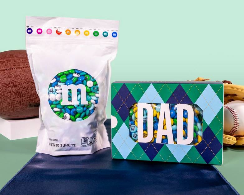 Bulk bag and gift box on table with football and baseball glove and ball