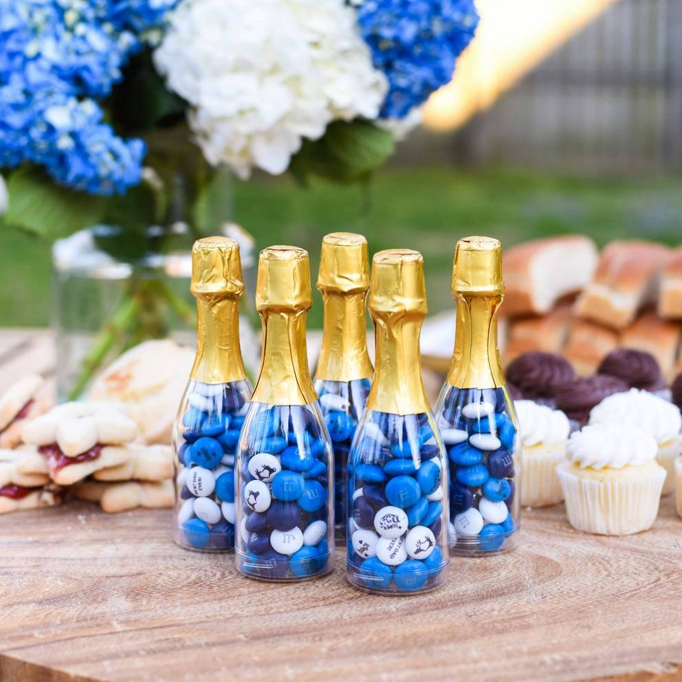 mini occasion bottles filled with personalized M&M'S on table at a BBQ
