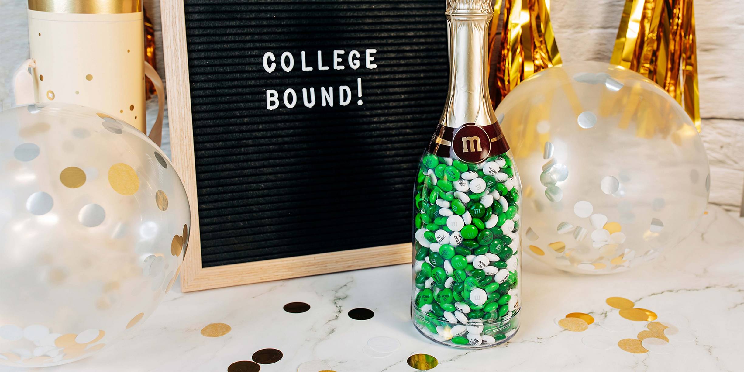 occasion bottle and letter board with decorations on table