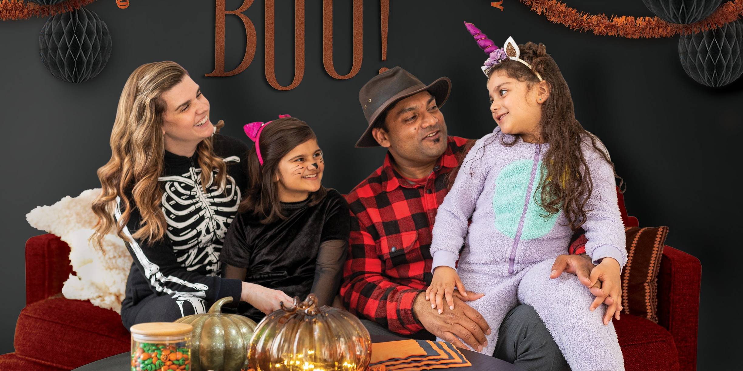 Family dressed up sitting on couch