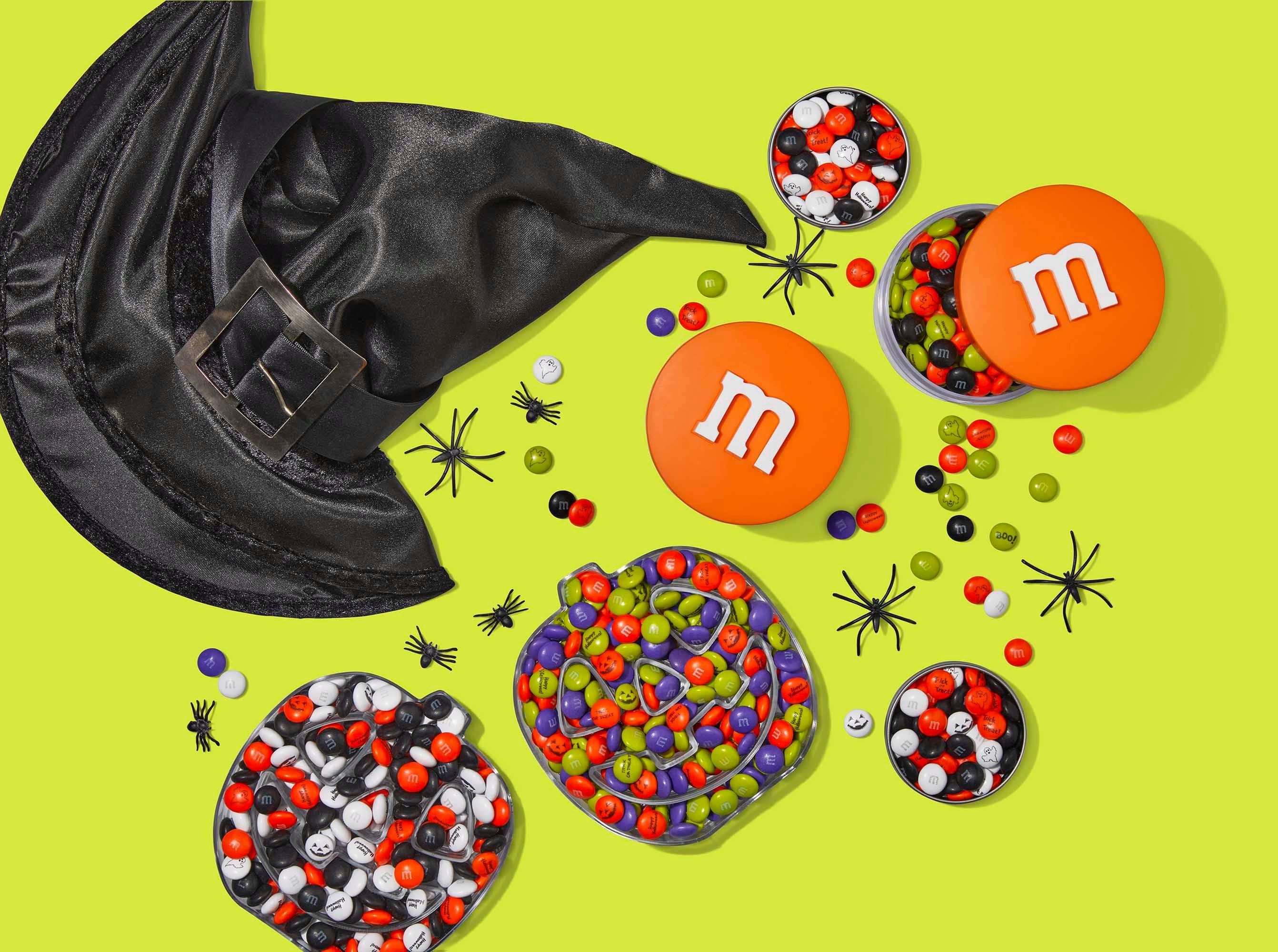 pumpkin gift boxes and stack 'm containers filled with candies and a witch hat