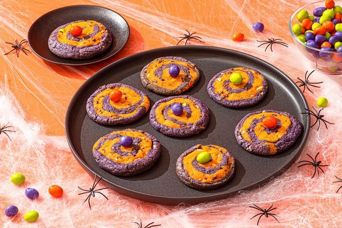 cookies on plate surrounded by spiders and webs