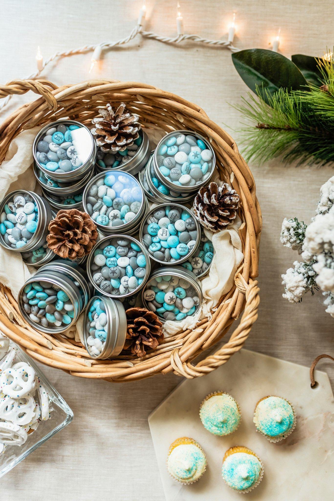silver favor tins with personalized M&M'S in a basket