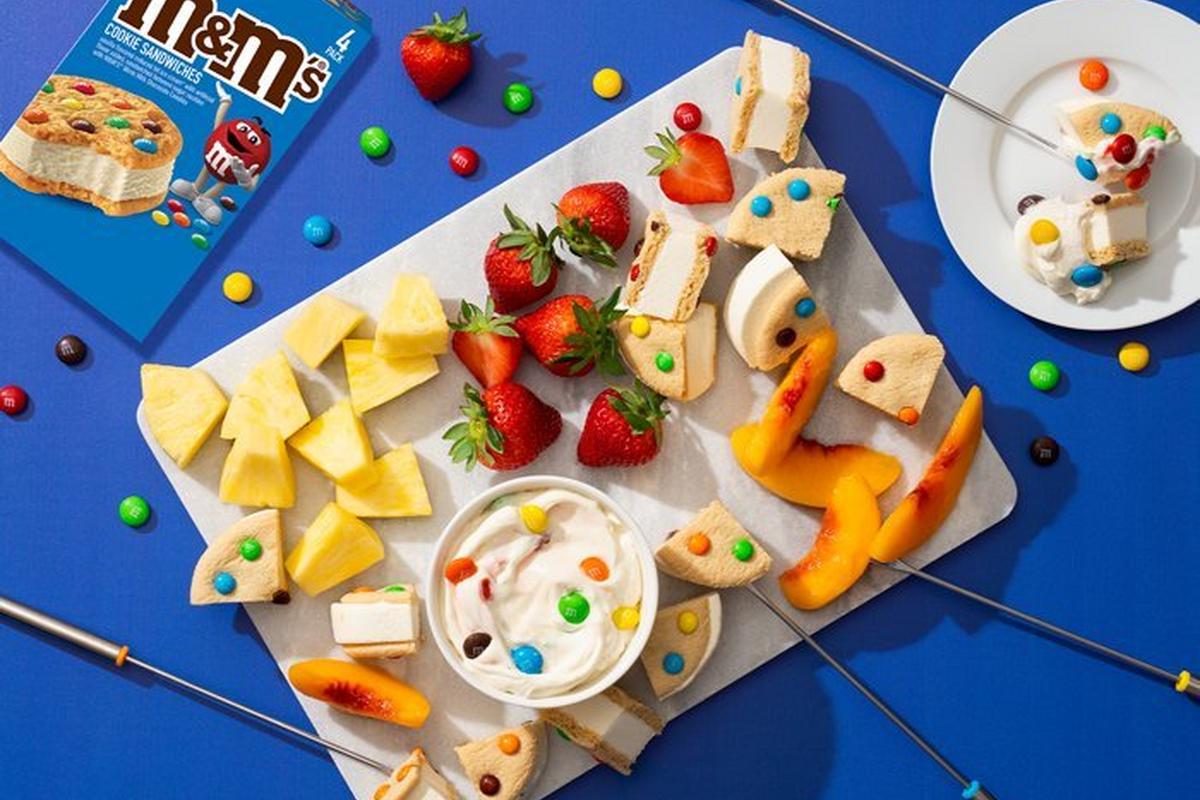 Ice cream sandwich board filled with fruit and ice cream sandwiches