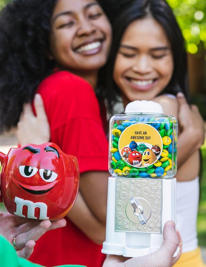 two friends hugging with red m&m's character mug & dispenser