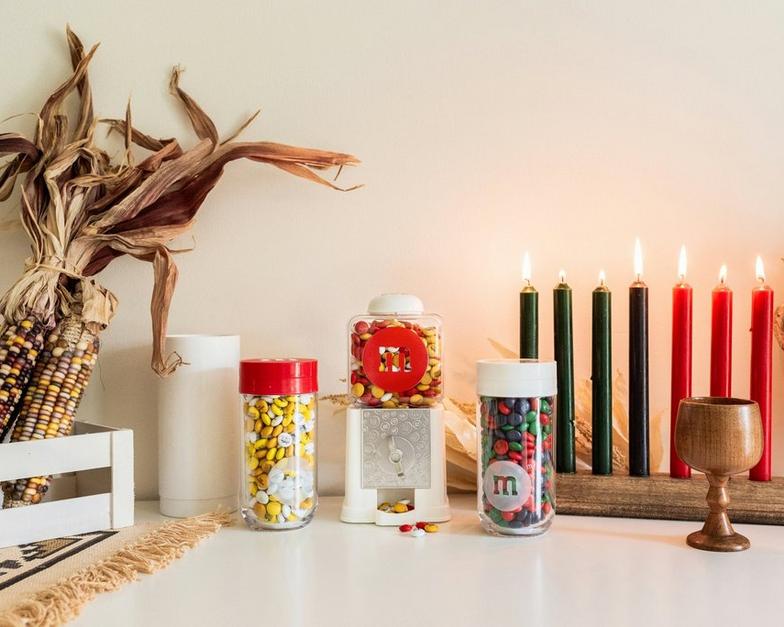 gift jars and dispenser on table with Kwanzaa kinara