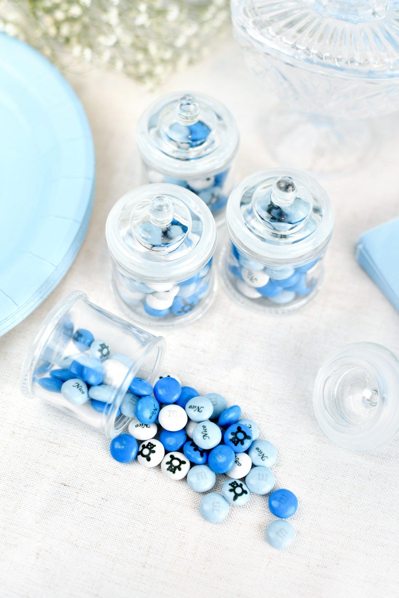 glass jar favors filled with blue and white M&M'S on table