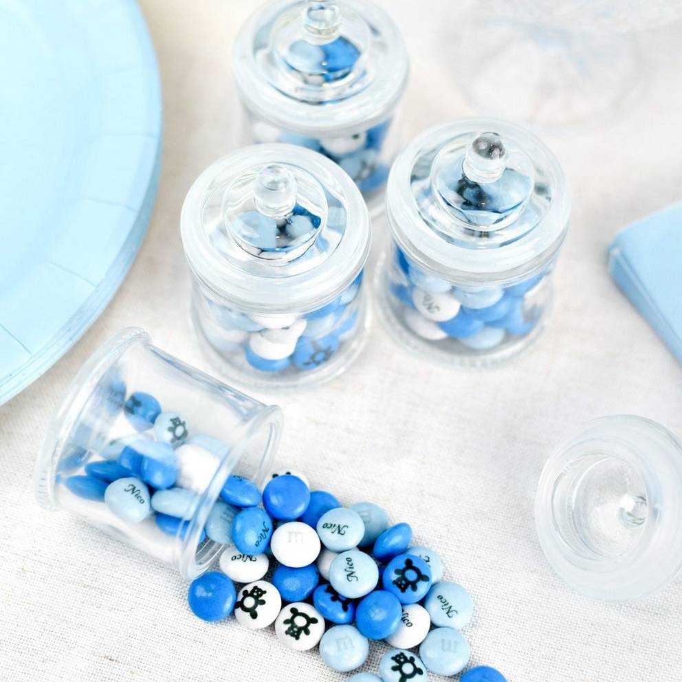 glass jar favors filled with blue and white M&M'S on table