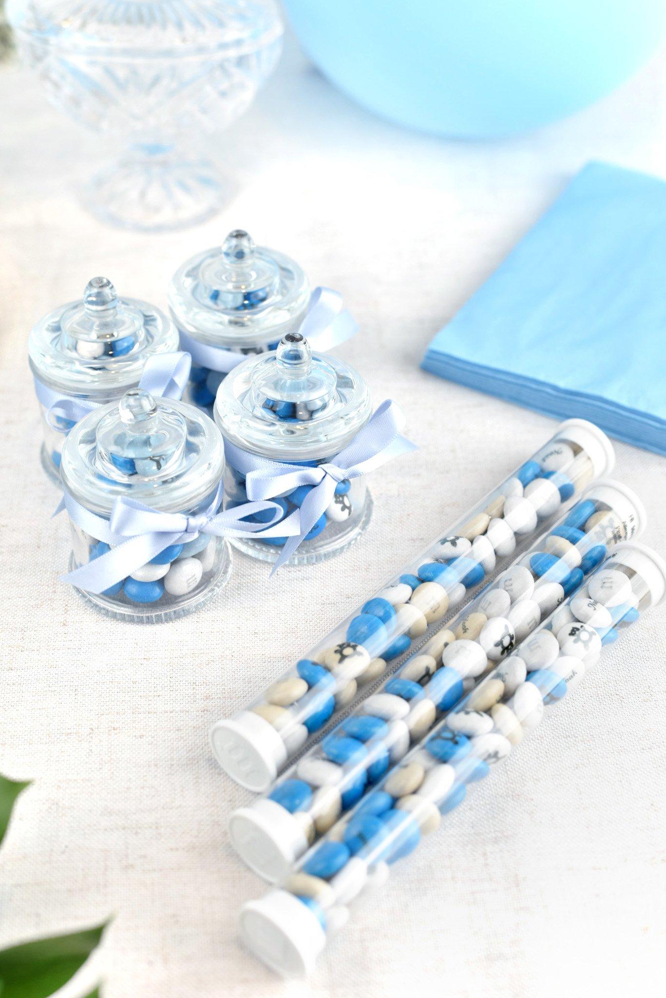 assorted party favors filled with blue and white M&M'S on table