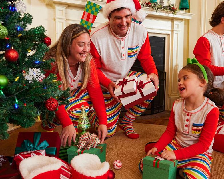 family on Christmas morning all wearing matching M&M'S holiday lounge sets