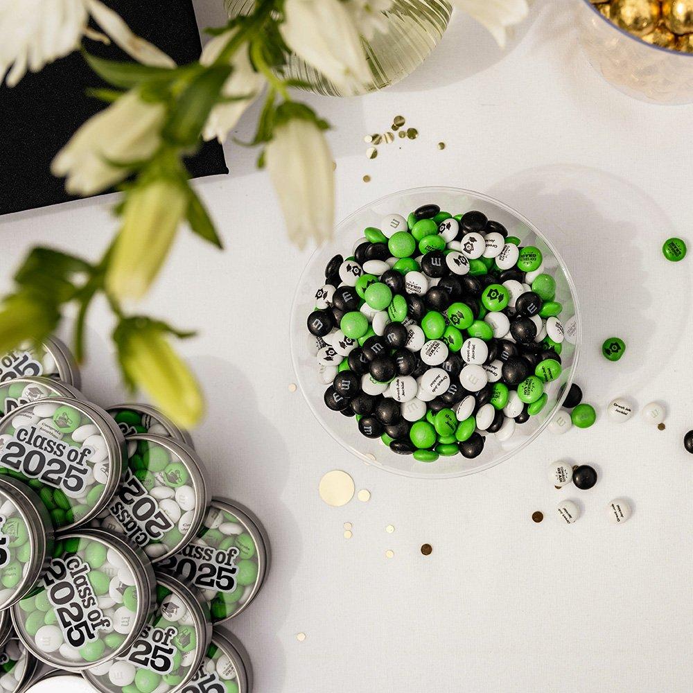 a graduation dessert table with M&M'S favors and personalized candy