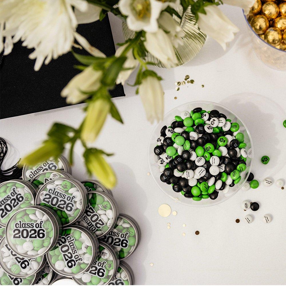 a graduation dessert table with M&M'S favors and personalized candy