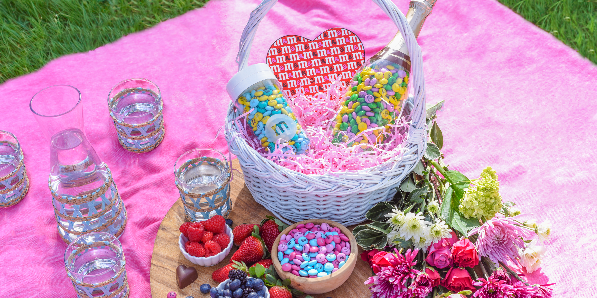 assorted M&M'S in different containers in a picnic basket