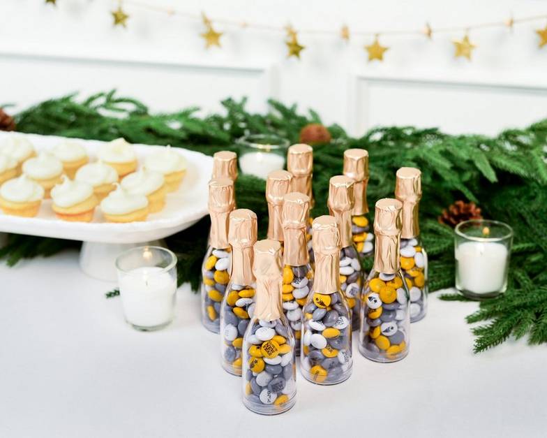 mini occasion bottles on a dessert table