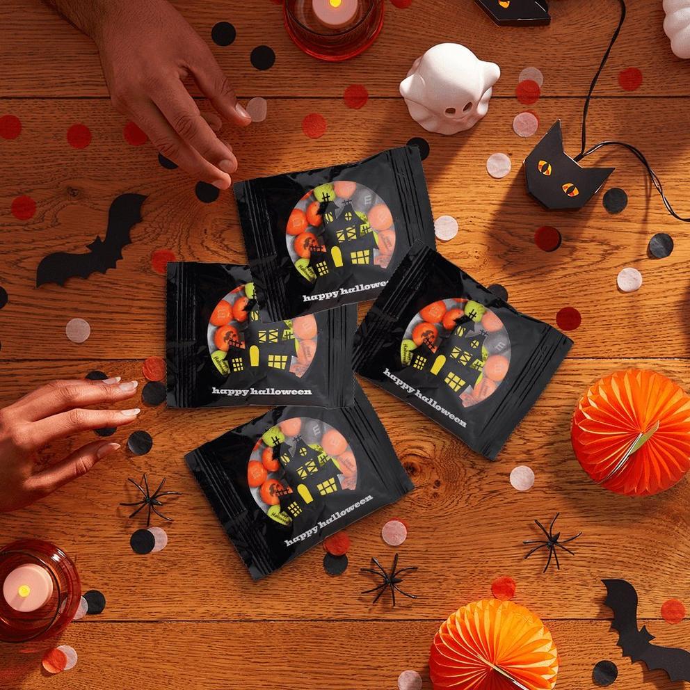 Pile of Halloween favor packs with hands reaching for them