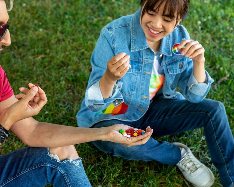 Two friends sharing M&M'S